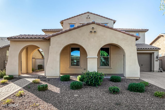 mediterranean / spanish-style home with a garage