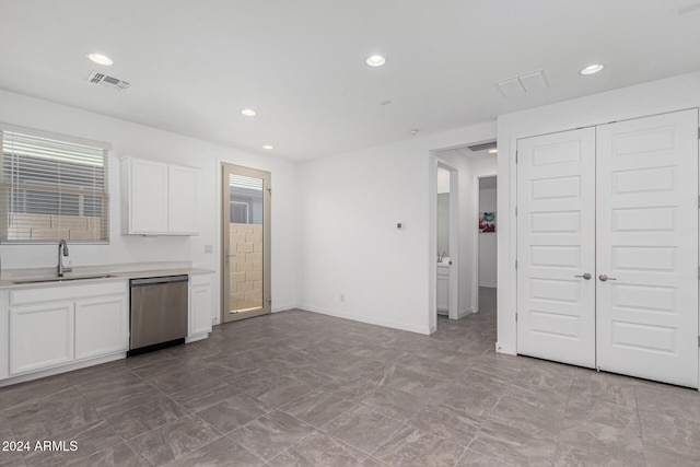 kitchen featuring dishwasher, white cabinetry, and sink