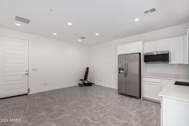 kitchen featuring white cabinetry, sink, and appliances with stainless steel finishes