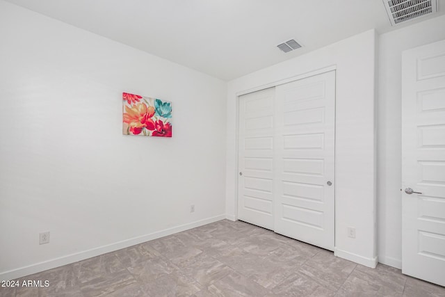 unfurnished bedroom with a closet