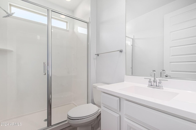 bathroom with vanity, toilet, and walk in shower