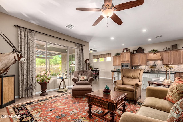 living area with baseboards, visible vents, a ceiling fan, and recessed lighting