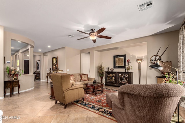 living room featuring ceiling fan, visible vents, baseboards, and recessed lighting