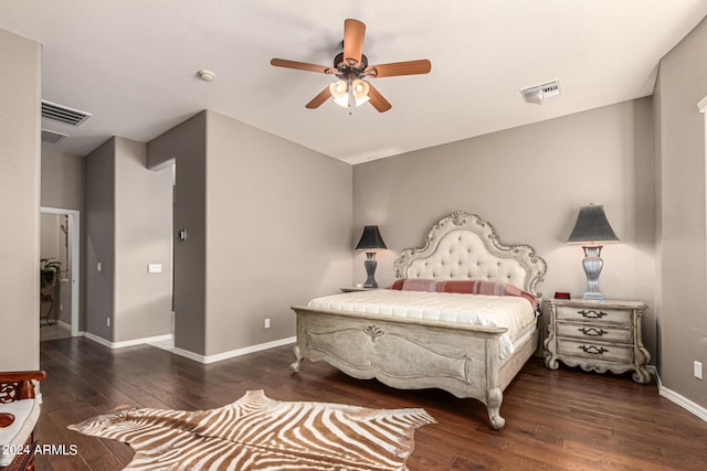 bedroom with dark wood-style floors, visible vents, baseboards, and a ceiling fan