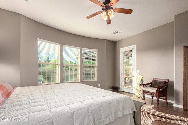 bedroom featuring baseboards, visible vents, ceiling fan, wood finished floors, and access to outside