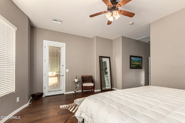 bedroom with access to outside, wood finished floors, visible vents, and baseboards