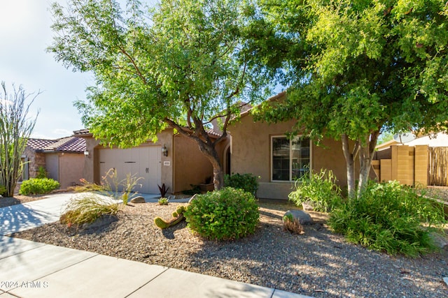 view of front of property with a garage, concrete driveway, and stucco siding