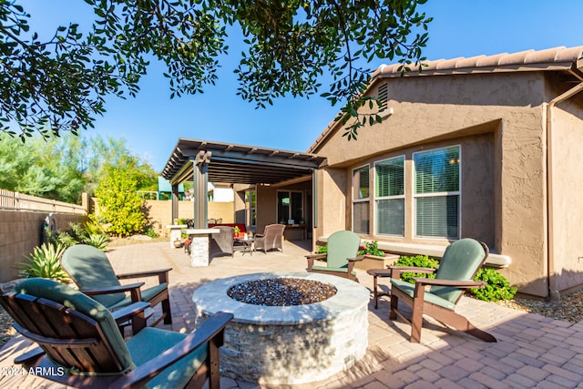 view of patio with an outdoor fire pit and a fenced backyard