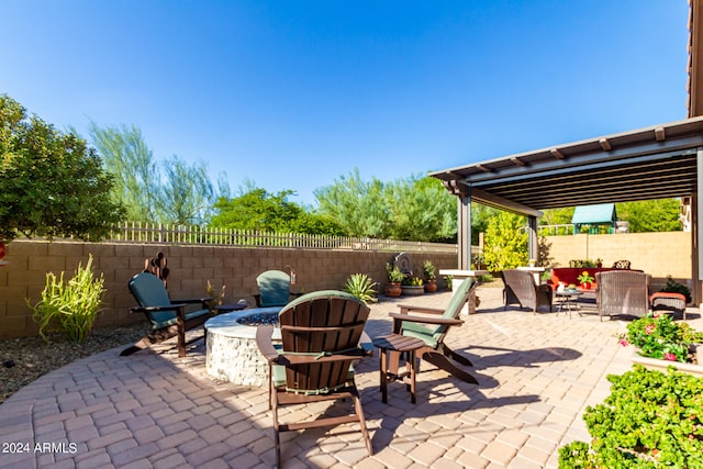 view of patio with an outdoor fire pit and a fenced backyard