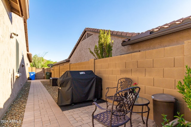 view of patio with a grill and fence