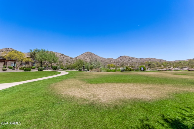 view of property's community with a mountain view and a yard