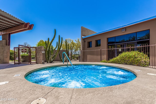 view of swimming pool featuring fence