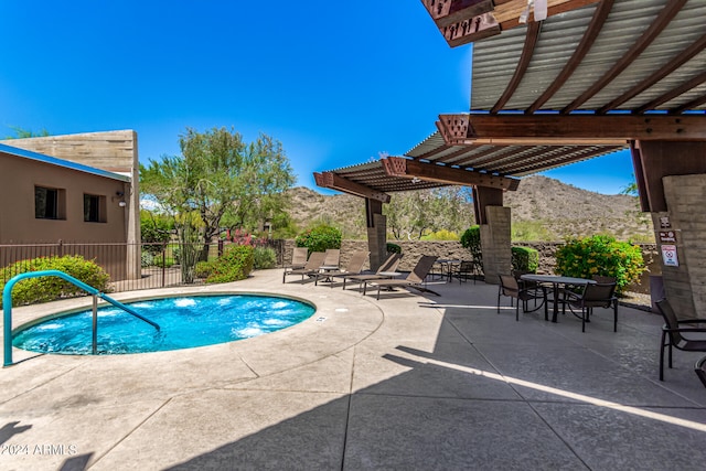 view of swimming pool featuring a mountain view, fence, a pergola, a swimming pool, and a patio area