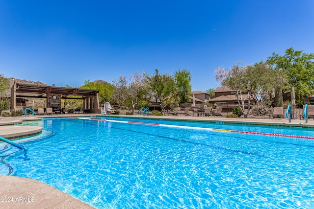 pool with a jacuzzi and fence