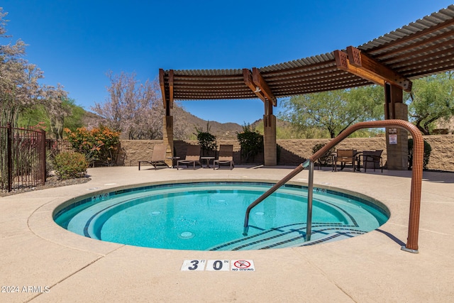 view of pool with a patio, fence, a mountain view, and a pergola