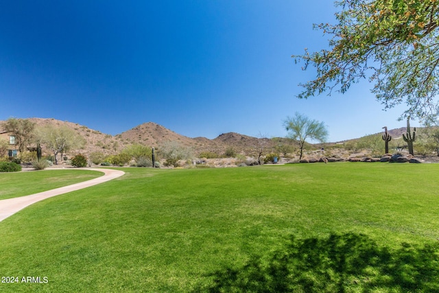 view of home's community featuring a mountain view and a lawn