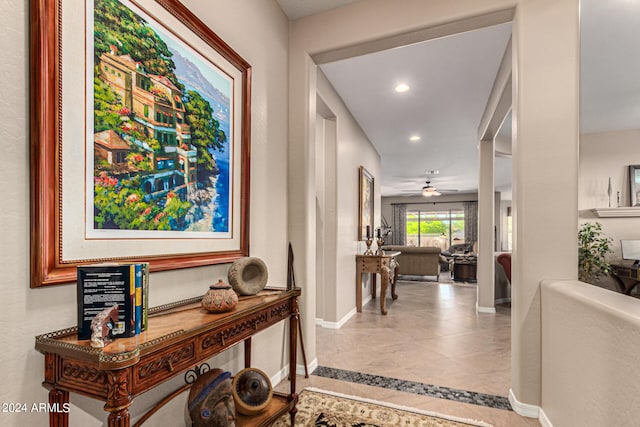 hallway with recessed lighting and baseboards