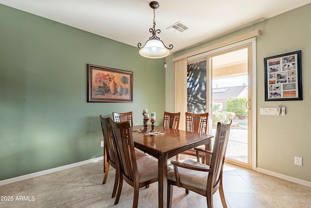 dining area with light tile patterned floors, visible vents, and baseboards