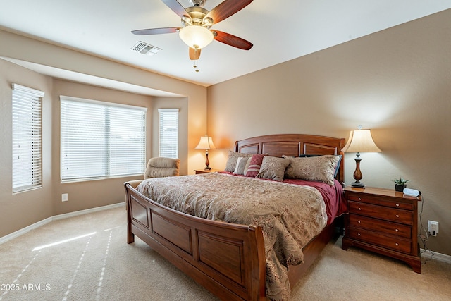 bedroom featuring baseboards, ceiling fan, visible vents, and light colored carpet