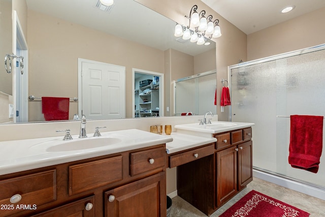 bathroom with visible vents, a sink, and a shower stall