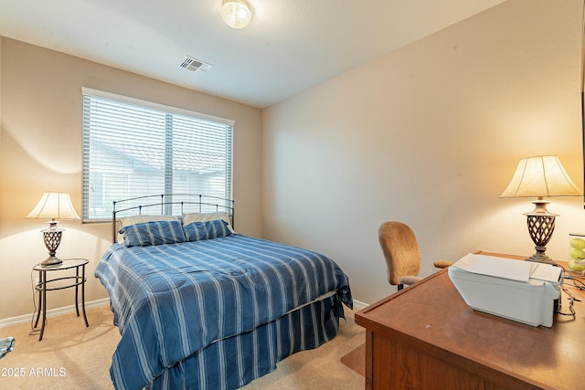 bedroom with baseboards, visible vents, and light colored carpet