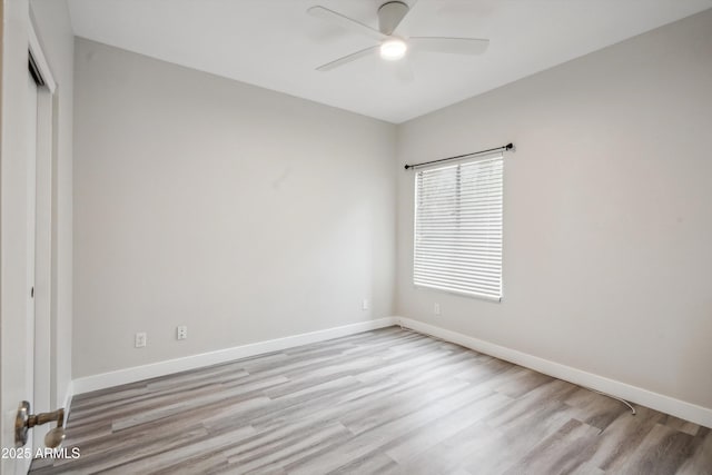 unfurnished room featuring ceiling fan, wood finished floors, and baseboards