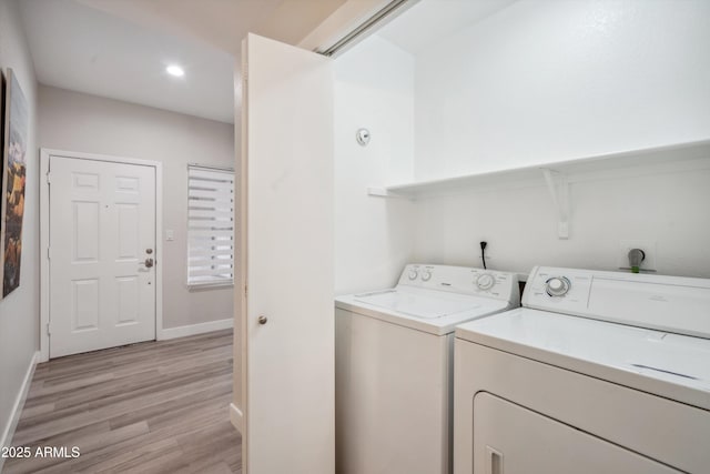 laundry area featuring washer and dryer, light wood finished floors, baseboards, and recessed lighting