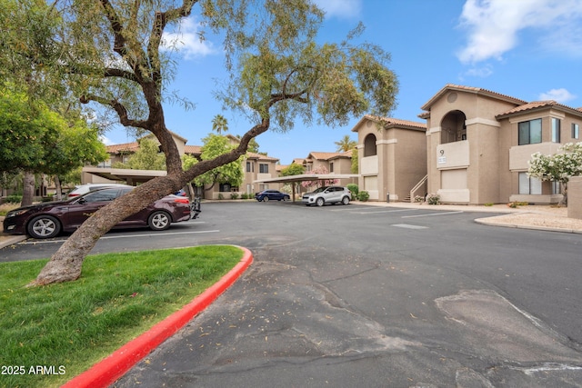 uncovered parking lot featuring a residential view
