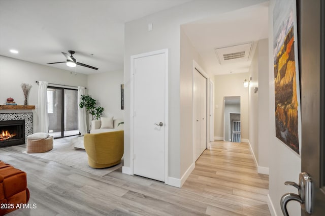 hallway featuring light wood-style floors and baseboards