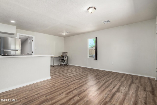 1424 S Bonarden Ln, Tempe, AZ 85281 - spare room with a textured ceiling, wood finished floors, baseboards, and visible vents