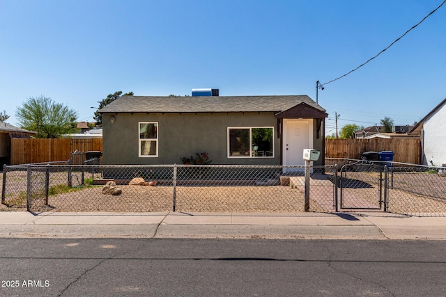1424 S Bonarden Ln, Tempe, AZ 85281 - view of front of property with a fenced front yard, roof with shingles, a gate, and stucco siding