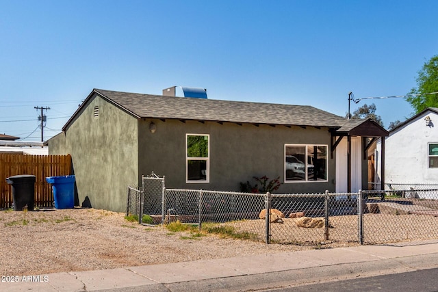 1424 S Bonarden Ln, Tempe, AZ 85281 - view of front of property featuring a shingled roof, stucco siding, and a fenced front yard