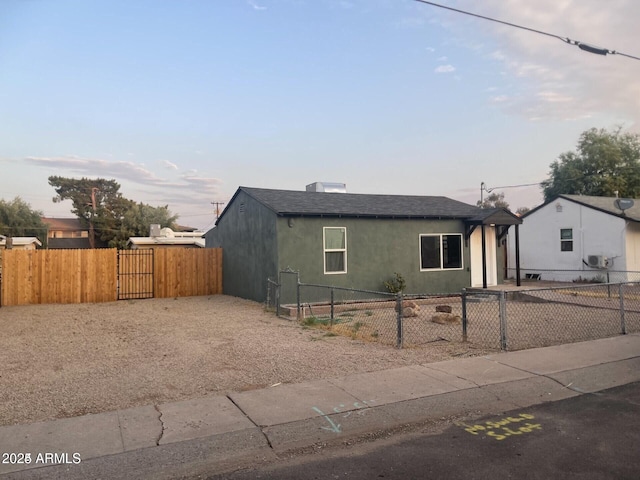 1424 S Bonarden Ln, Tempe, AZ 85281 - bungalow-style home featuring a shingled roof, a gate, stucco siding, and a fenced front yard