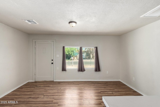 1424 S Bonarden Ln, Tempe, AZ 85281 - empty room with a textured ceiling, wood finished floors, and visible vents