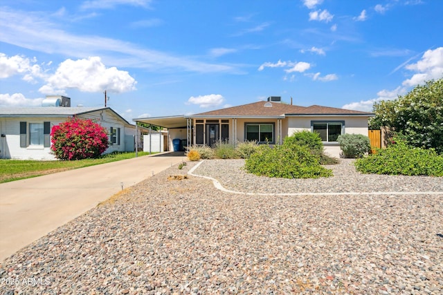 2726 E Fairmount Ave, Phoenix, AZ 85016 - ranch-style house with concrete driveway, stucco siding, fence, and a carport