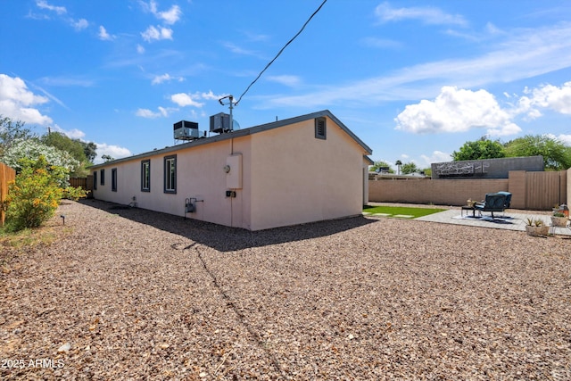 2726 E Fairmount Ave, Phoenix, AZ 85016 - rear view of property featuring central AC, a fenced backyard, a patio area, and stucco siding
