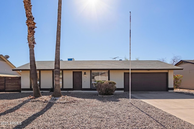 view of front of house featuring driveway, an attached garage, and stucco siding