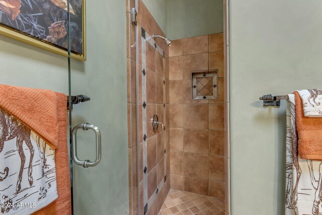 bathroom with a shower with shower door