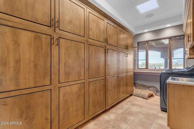 interior space featuring washer / dryer and a skylight