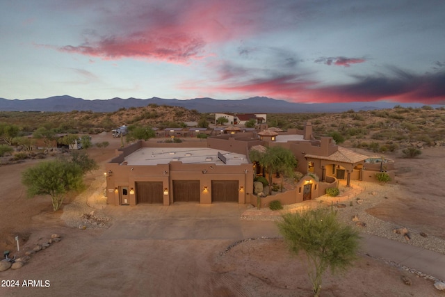 view of front facade featuring a mountain view and a garage