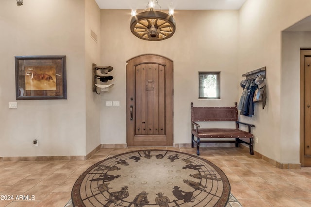 foyer entrance featuring a notable chandelier