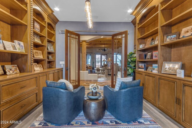 living area featuring french doors and light hardwood / wood-style flooring