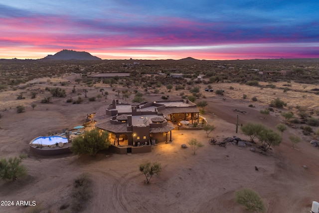 aerial view at dusk featuring a mountain view