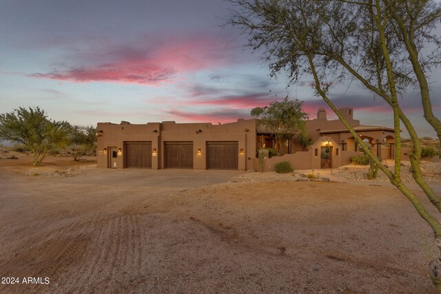 adobe home featuring a garage