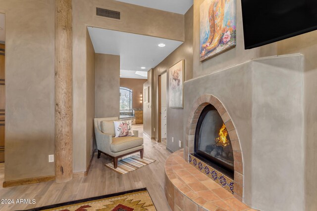 living area featuring hardwood / wood-style flooring and a fireplace