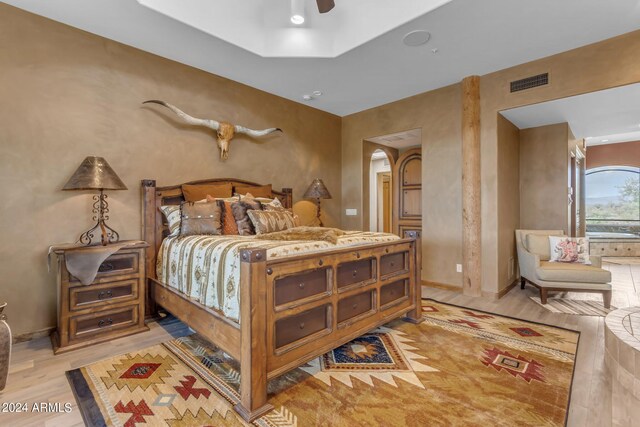 bedroom with ceiling fan and light wood-type flooring