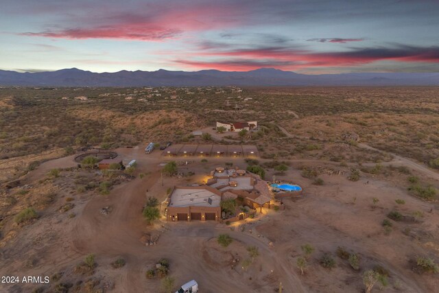 aerial view at dusk featuring a mountain view