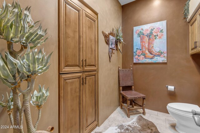 bathroom with tile patterned flooring and toilet