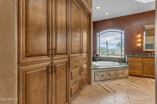 bathroom with vanity, tile patterned floors, and a bathtub