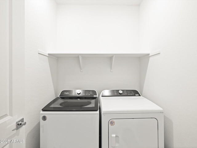 laundry area featuring washing machine and clothes dryer and laundry area